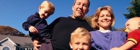 Family in front of their home.